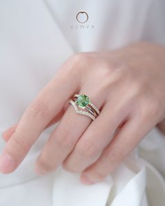 Cushion-cut bluish green tourmaline gemstone ring with three row stack diamond eternity bands