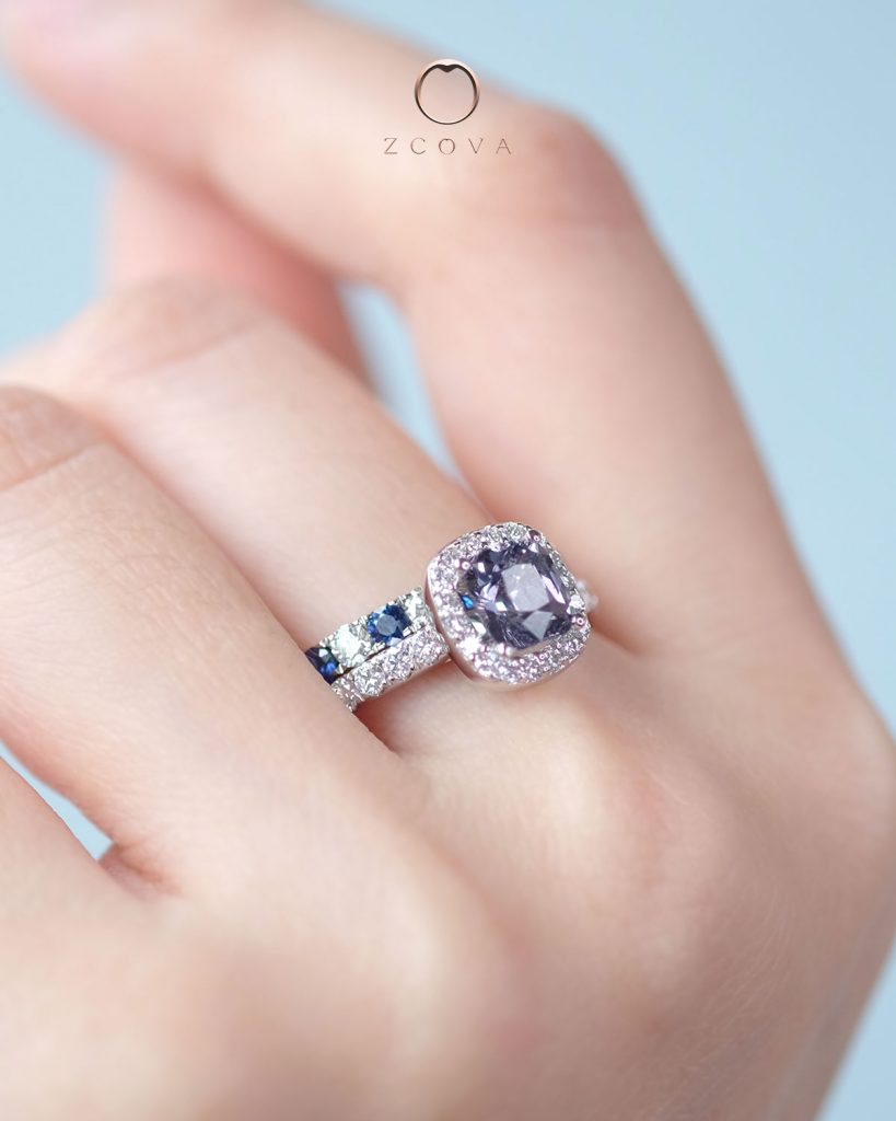 Light grey spinel gemstone ring paired with blue sapphire and diamond eternity band