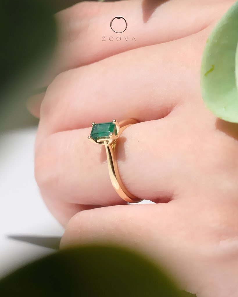 Octagon green emerald gemstone four prong tulip setting yellow gold