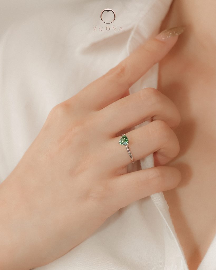 Triangular bluish green toumaline gemstone with simple solitaire ring design in white gold