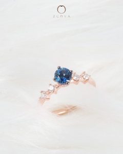 Round blue sapphire gemstone with side diamonds engagement ring