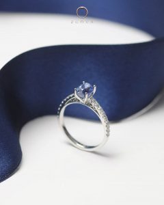 Cornflower blue sapphire engagement ring in vintage cathedral ring design