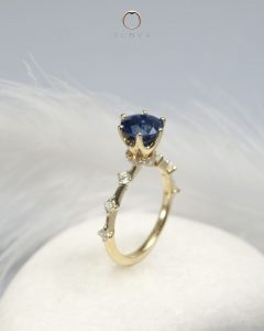 Round cut blue sapphire gemstone engagement ring with pave diamonds