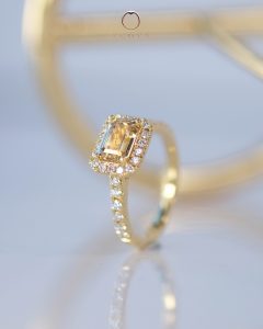 Emerald-cut Yellow fancy sapphire with halo diamond engagement ring