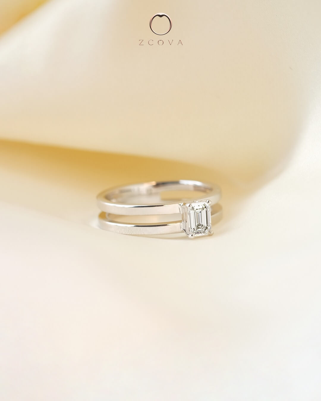 emerald shaped diamond with split shank engagement ring setting