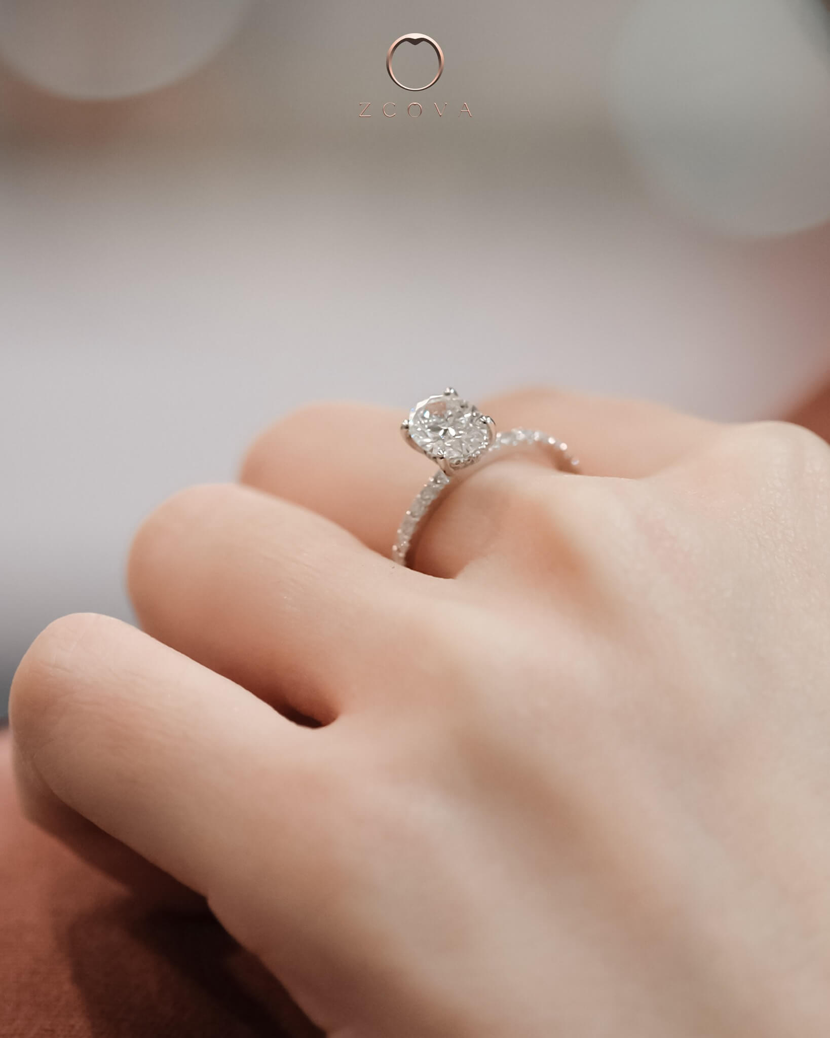 oval diamond pave engagement ring setting on ring finger