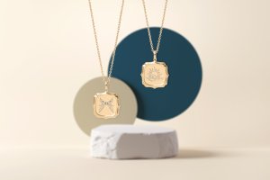 two gold pendants with engraving