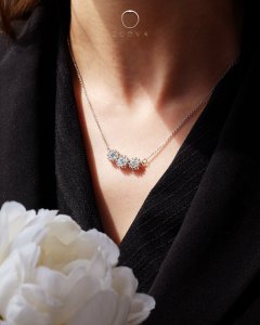 3 diamond stone bespoke necklace on woman's neck wearing black with flower decor